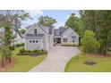 Gorgeous two-story home with manicured lawn, lovely landscaping, and a spacious driveway at 14 Duck Bill Trl, Pittsboro, NC 27312