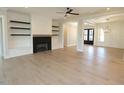 Bright living room with fireplace, built-ins, hardwood floors, and an open floor plan at 14 Duck Bill Trl, Pittsboro, NC 27312