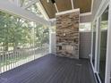 Enjoy the outdoors in this screened porch with a stone fireplace and wooded view at 14 Duck Bill Trl, Pittsboro, NC 27312