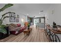 Bright living room boasts wood floors, modern decor, and an open layout to the kitchen at 145 Coleridge Ct, Carrboro, NC 27510