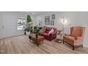 Bright living room boasts wood floors, modern decor, and a comfortable seating area at 145 Coleridge Ct, Carrboro, NC 27510