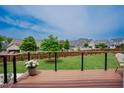Deck with wood floors, black cable rails, and a view of the backyard at 2020 Cotton Barn Ct, Wendell, NC 27591