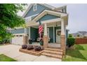Inviting front porch with brick steps, decorative plants, and a cozy seating area at 2020 Cotton Barn Ct, Wendell, NC 27591