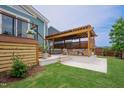 Backyard pergola with cushioned seating and a hot tub, perfect for outdoor relaxation at 2020 Cotton Barn Ct, Wendell, NC 27591