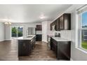 Modern kitchen featuring stainless steel appliances, dark cabinets, and an island with a sink at 221 Hallow Oak St, Spring Lake, NC 28390