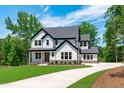 Attractive two-story house with lush lawn, a long drive, and a welcoming facade, all under a blue sky at 248 Ashford Dr, Pittsboro, NC 27312