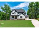 Beautiful two-story home boasts a manicured lawn, ample foliage, and a long driveway leading to the house at 248 Ashford Dr, Pittsboro, NC 27312