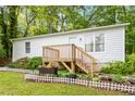 Single-story home featuring a wooden deck with a cute flower box and garden at 2612 Wade Hampton Rd, Hillsborough, NC 27278