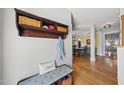 Inviting entryway with hardwood floors, coat rack, and storage bench, leading to dining room at 300 Redhill Rd, Holly Springs, NC 27540
