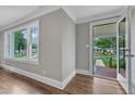 Sunlit living area with hardwood floors, neutral walls, and view of front yard at 302 Hester St, Knightdale, NC 27545