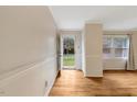 Light-filled foyer with hardwood floors, white trim, and paneled walls, leading to outdoors at 3329 Broughton Dr, Durham, NC 27704