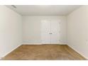 Neutral bedroom with plush carpeting and double doors, creating a peaceful retreat at 350 Pillow Ln, Burlington, NC 27217