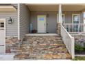 Inviting front porch steps with stone accents and manicured landscaping that leads to the front door at 351 Lowery Ln, Benson, NC 27504