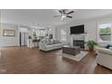 Bright, open-concept living room with hardwood floors, a fireplace, and a view into the kitchen at 351 Lowery Ln, Benson, NC 27504