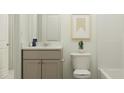 Cozy bathroom with modern vanity, a clean white toilet, and neutral wall colors at 40 Regal Gardens Ct, Angier, NC 27501