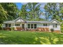 Charming single-story home with a brick foundation and well-manicured lawn at 418 S West St, Cary, NC 27511