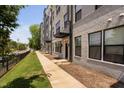 Exterior view of modern townhomes with landscaped walkways and well-maintained green spaces at 421 Wait Ave # 100, Wake Forest, NC 27587