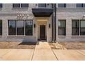 The townhome showcases its modern brick facade, covered entrance, and clear unit number at 421 Wait Ave # 100, Wake Forest, NC 27587
