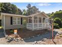 Front exterior view of a inviting ranch home with a cozy front porch and fresh landscape at 4701 Governor Hunt St, Efland, NC 27243