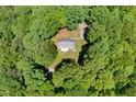 Birds eye view of house with a gray roof nestled in trees with a circular driveway at 560 Parker Creek Rd, Holly Springs, NC 27540