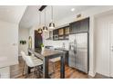 Well-appointed kitchen with a dining table, stainless steel appliances and dark cabinets at 601 W Rosemary St # 715, Chapel Hill, NC 27516