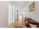 Inviting hallway featuring gleaming hardwood floors and elegant console table at 637 Marrian Dr, Clayton, NC 27520