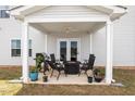 Cozy covered patio featuring outdoor seating and grill, perfect for entertaining at 637 Marrian Dr, Clayton, NC 27520