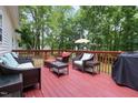Spacious wooden deck with outdoor furniture, perfect for relaxing and enjoying the surrounding lush greenery at 687 W Watson Rd, Benson, NC 27504