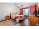 Comfortable bedroom featuring a large window, a queen-sized bed, and warm, inviting color accents at 687 W Watson Rd, Benson, NC 27504