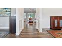 Bright hallway with hardwood flooring and decorative wall paneling, leading to a spacious living area at 7801 Charters End St, Willow Springs, NC 27592