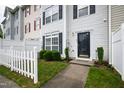 Well-manicured front lawn and a black front door create a charming entrance at 8610 Neuse Landing Ln # 103, Raleigh, NC 27616
