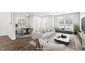 Bright living room with hardwood floors, large windows, and stylish furnishings at 8610 Neuse Landing Ln # 103, Raleigh, NC 27616