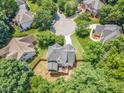 Aerial view showcasing backyard, mature trees and the privacy provided by the wooden fence at 1001 Dairy House Ct, Wake Forest, NC 27587