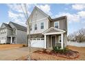 Charming two-story home features a two-car garage, beautiful stone accents, and covered entry at 1016 Matterhorn Dr, Fuquay Varina, NC 27526