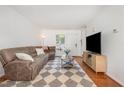 Bright living room features a plush sectional sofa, hardwood floors, front door and bright natural light at 103 Coleridge Ct, Carrboro, NC 27510