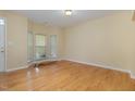 Bright living room featuring hardwood flooring, bay windows and fresh paint at 1031 Lake Moraine Pl, Raleigh, NC 27607