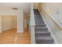 Inviting view of the carpeted staircase with living room space with beautiful hardwood floors at 1031 Lake Moraine Pl, Raleigh, NC 27607