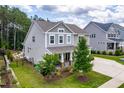 Well-maintained home exterior showcasing a landscaped yard, a welcoming porch, and a side entry garage at 113 Hidden Bluff Dr, Chapel Hill, NC 27517