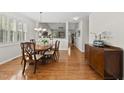 Dining room with chandelier, hardwood floors, and access to the living room and entryway at 12505 Garden Tree Ln, Raleigh, NC 27614