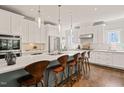 Bright kitchen featuring white cabinets, stainless steel appliances, and a large island with seating at 129 Ruskin Dr, Chapel Hill, NC 27516