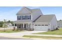 Attractive two-story home with a two-car garage, a covered front porch, and freshly laid lawn at 142 Benson Village Dr # 82, Benson, NC 27504