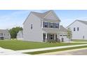 Exterior view of a modern two-story home with gray siding, a well-kept lawn, and simple landscaping at 142 Benson Village Dr # 82, Benson, NC 27504