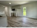 Bright kitchen featuring modern cabinets, sleek countertops and laminate flooring, perfect for cooking at 159 Coharie Dr, Lillington, NC 27546