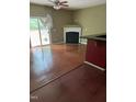 Spacious living room with hardwood floors, a fireplace, and natural light at 1671 Holly Grove Way, Durham, NC 27713