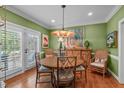 Cozy dining room featuring a round table, rattan chairs, and a door to the outside at 1813 Carrington Dr, Raleigh, NC 27615