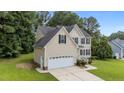 Beautiful two-story home featuring well-kept lawn and a convenient two-car attached garage at 185 Keller Dr, Clayton, NC 27520