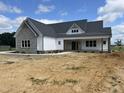 New construction home with stone accents, a covered porch, and fresh landscaping at 188 Banner Elk Rd, Benson, NC 27504
