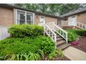Inviting brick home with a quaint entrance, lush greenery, and well-manicured landscaping at 200 W Woodcroft Pkwy # 57B, Durham, NC 27713