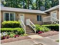 Delightful brick home with an inviting entrance, neat landscaping, and colorful floral accents at 200 W Woodcroft Pkwy # 57B, Durham, NC 27713