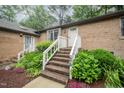 Attractive brick home boasting a welcoming entrance, vibrant floral arrangements, and established landscaping at 200 W Woodcroft Pkwy # 57B, Durham, NC 27713